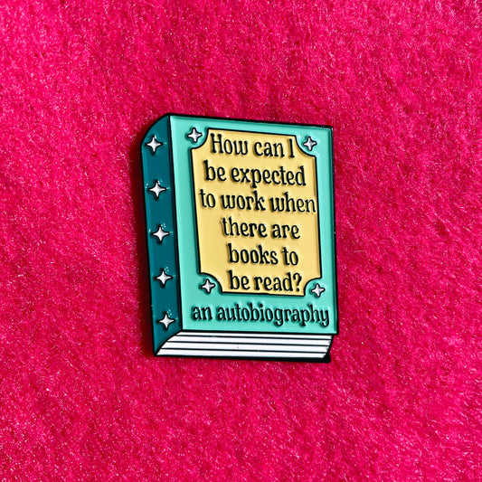 Book-shaped enamel pin with humorous quote on a pink background