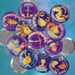 Collection of colorful zodiac buttons on a blue starry background